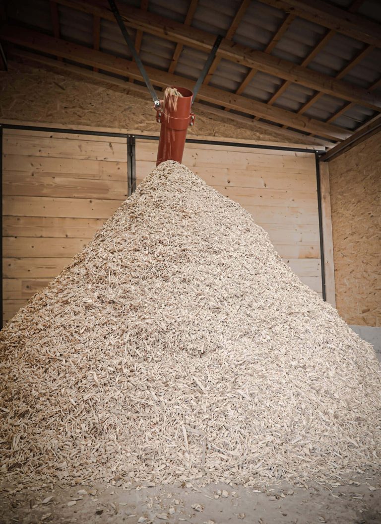 a pile of shredded wood chips is formed at the discharge area of the shredder