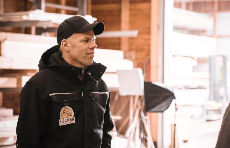 Arne Sucker stands in a woodworking shop