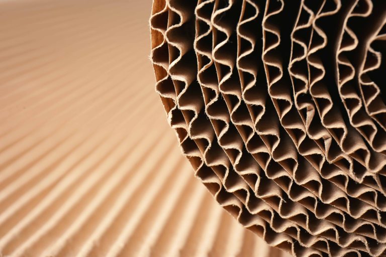 Closeup view of roll of brown corrugated cardboard.