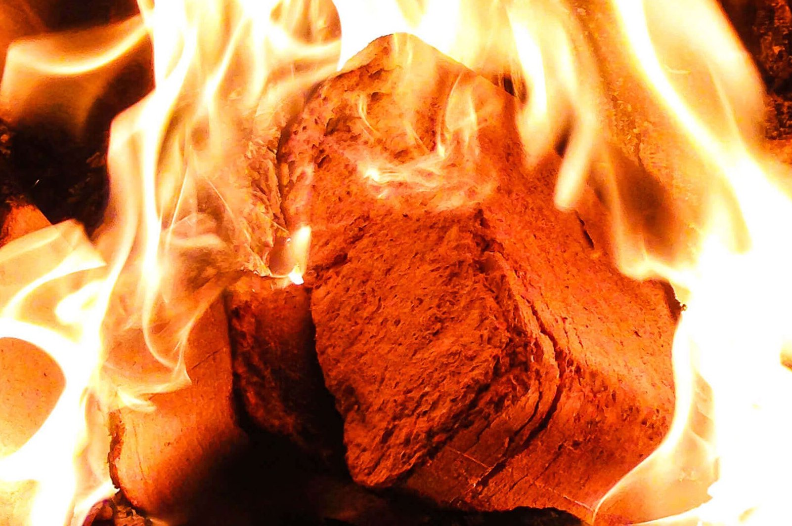 Square wooden briquettes are burnt in a wood burning oven