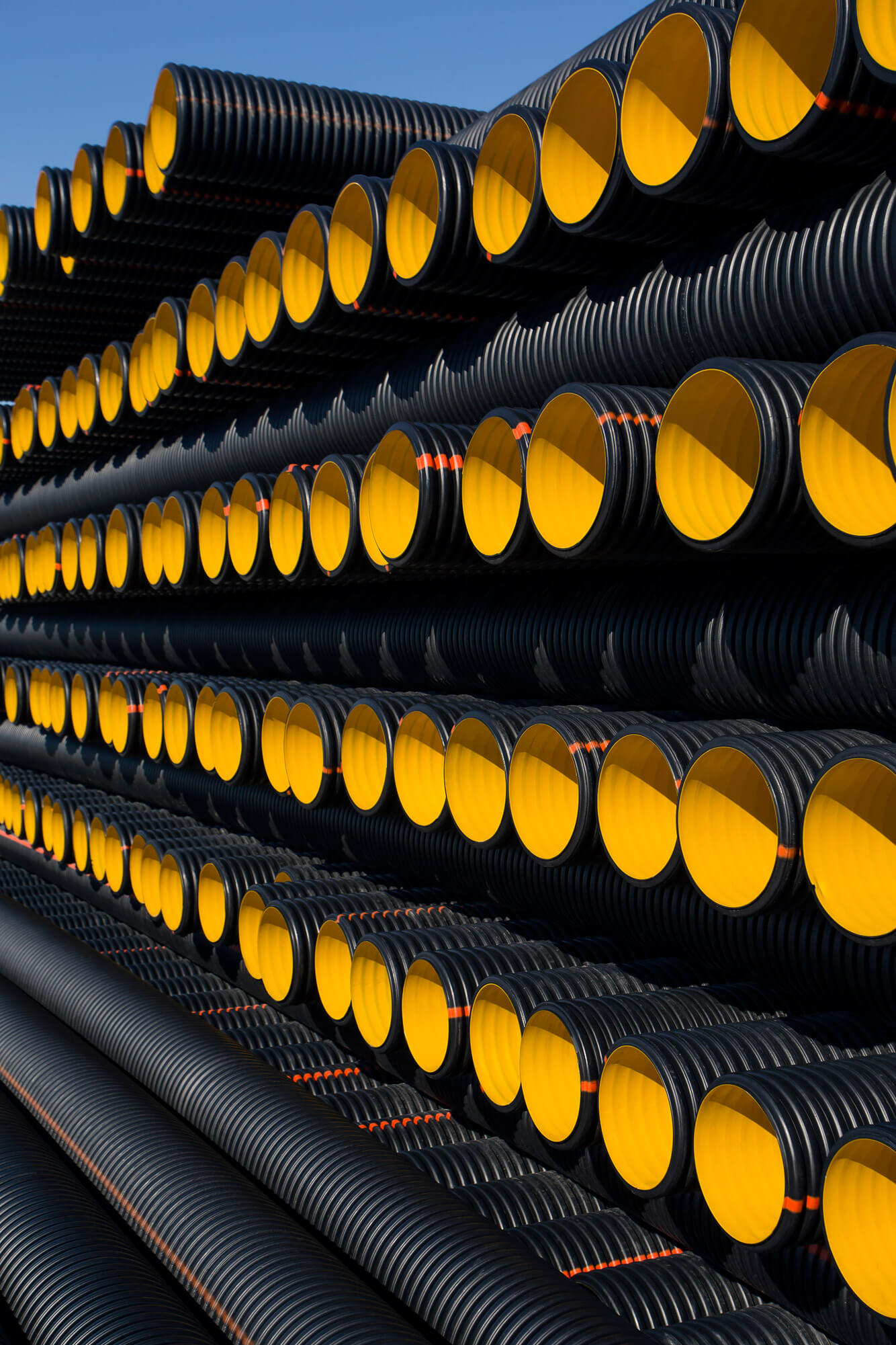 Polyvinyl chloride pipes are stored stacked