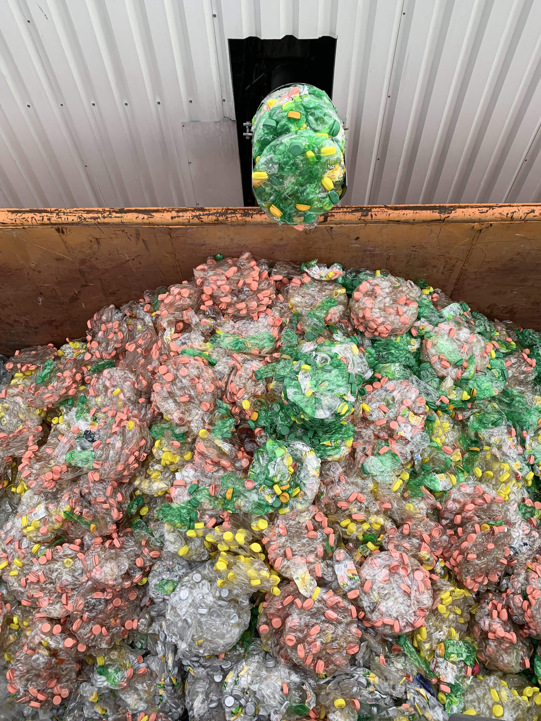 WEIMA PUEHLER Presse trägt gepresste Presslinge aus PET Flaschen in Container aus