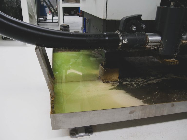 Cutting fluid is collected in a basin beneath the WEIMA briquette press