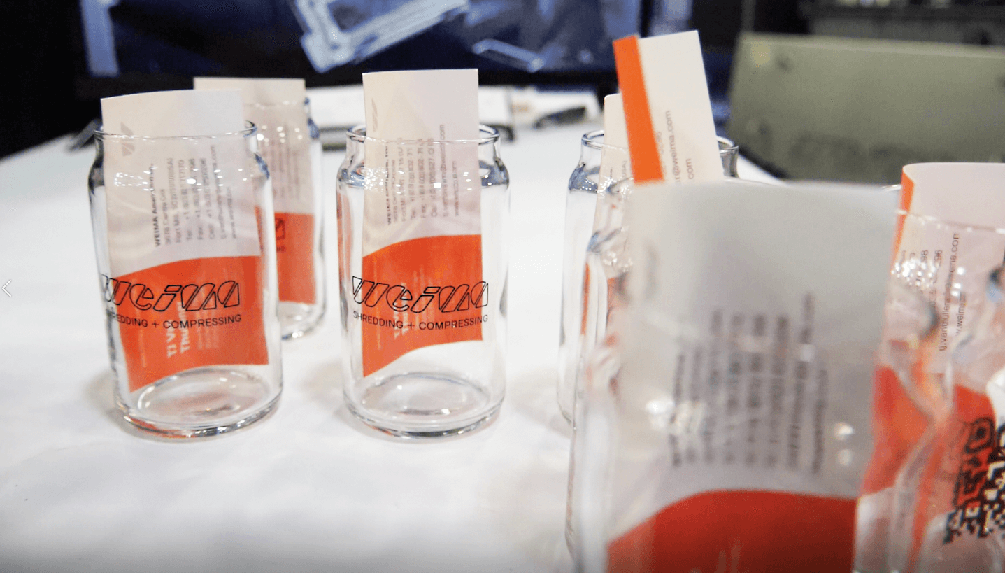 Small can-shaped glasses with WEIMA logo and a QR code on the back