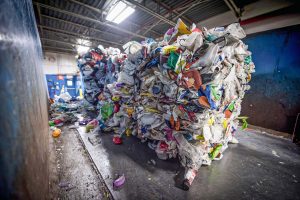 baled pst-consumer packaging on a conveyor belt