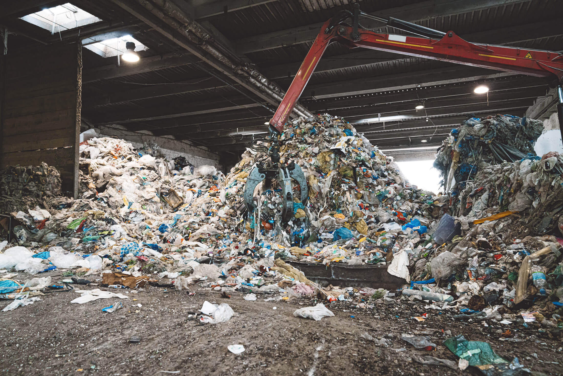mountain of commercial waste inside a waste treatment hall