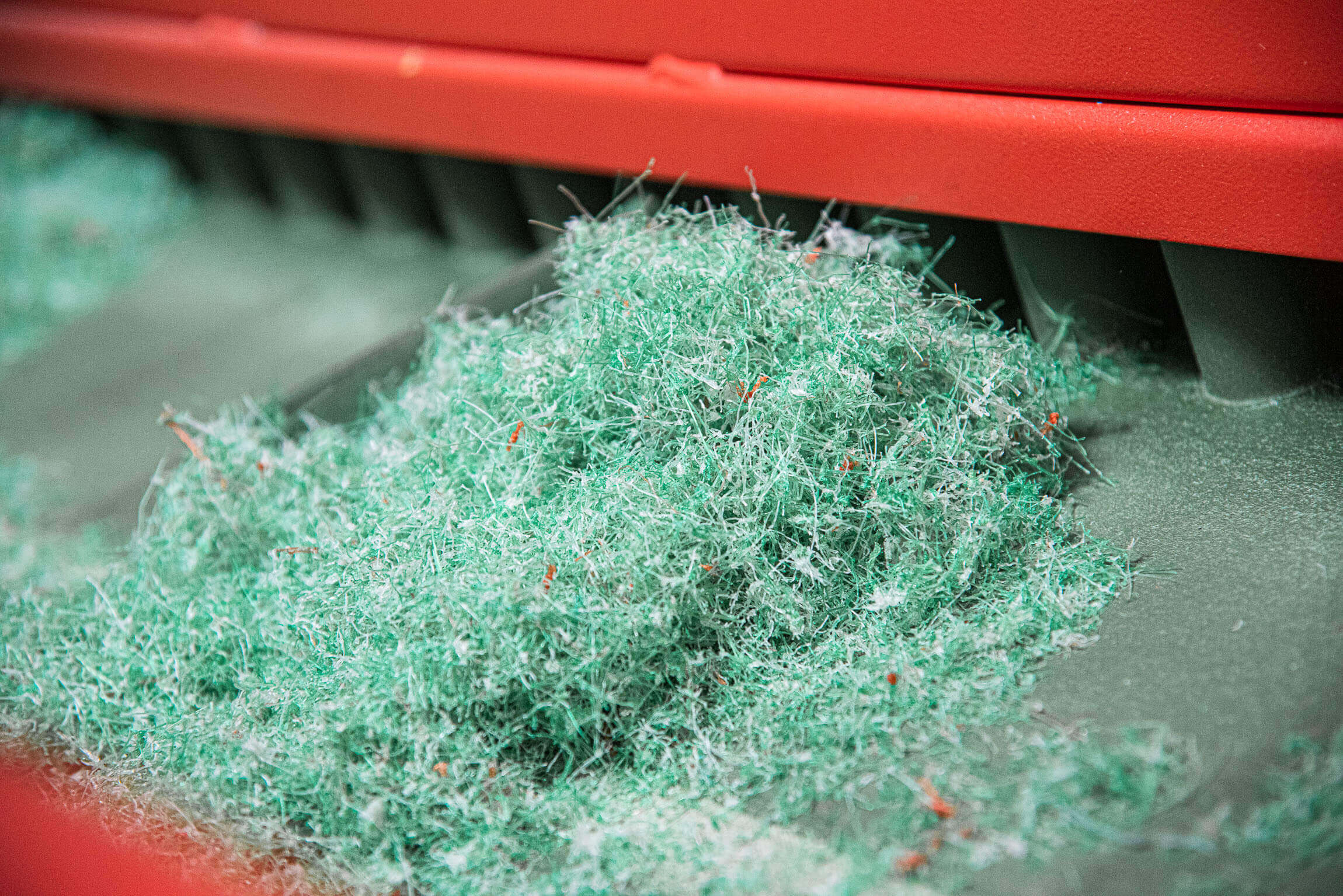 Shredded nylon fishing net on a conveyor belt