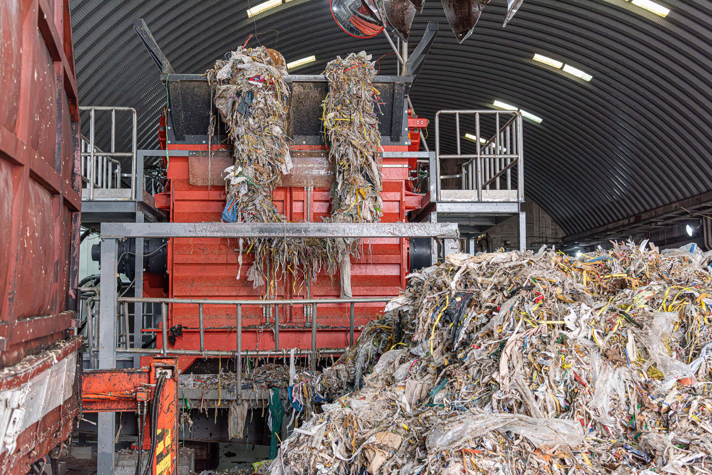 WEIMA PreCut 2500 shreds pulper waste from paper recycling process and is loaded by crane