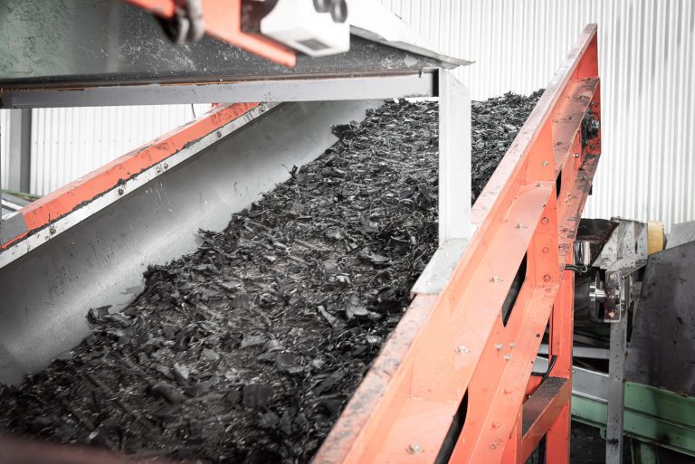 Shredded car tires on a conveyor belt