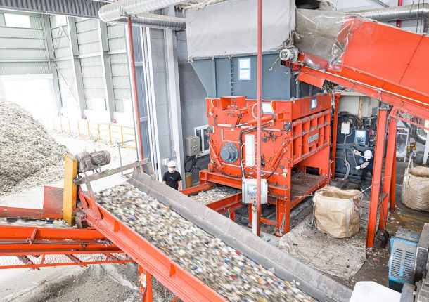orange shredder shredding municipal waste at a recycling company in South Korea