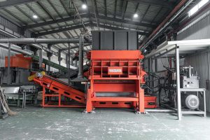 An orange shredder in South Korea that shreds old tires.