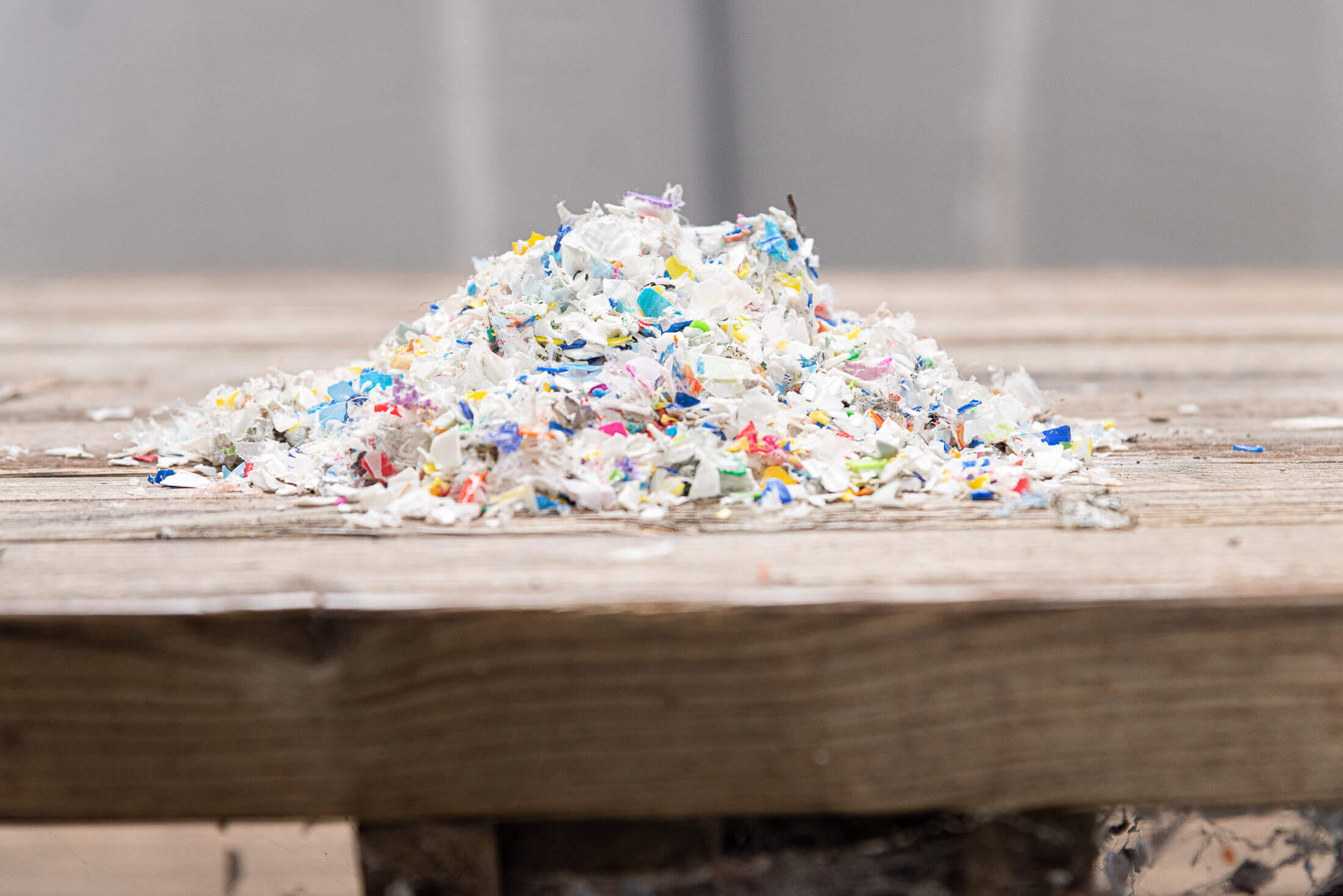 On a table are crushed, clean, colorful flakes