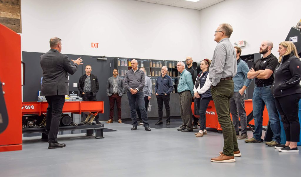 A group of committee members tour the shredding lab.