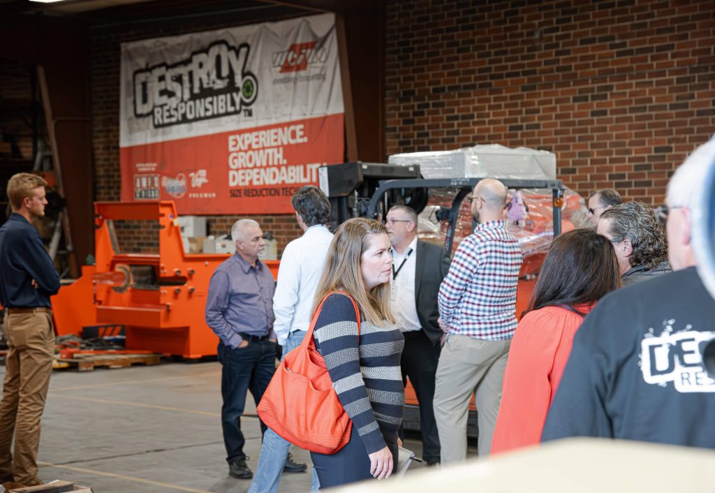 A group of recycling committee members tour the shop at WEIMA.
