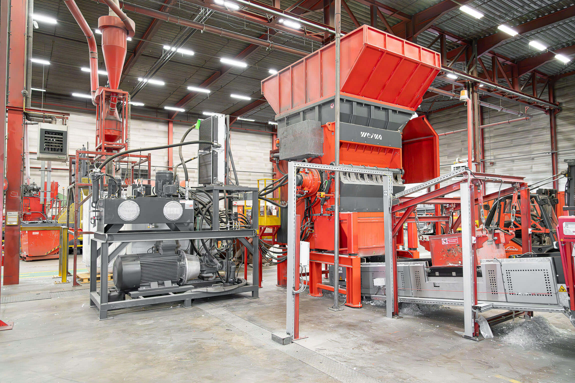 An orange-red shredder with hydraulic drive