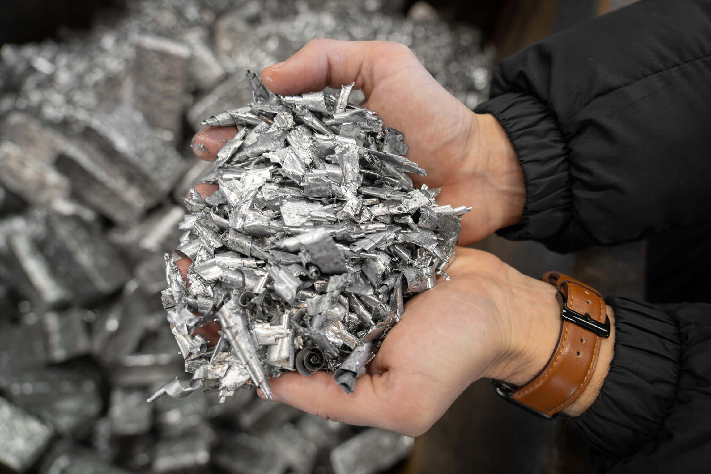 A pile of aluminium shavings in one hand