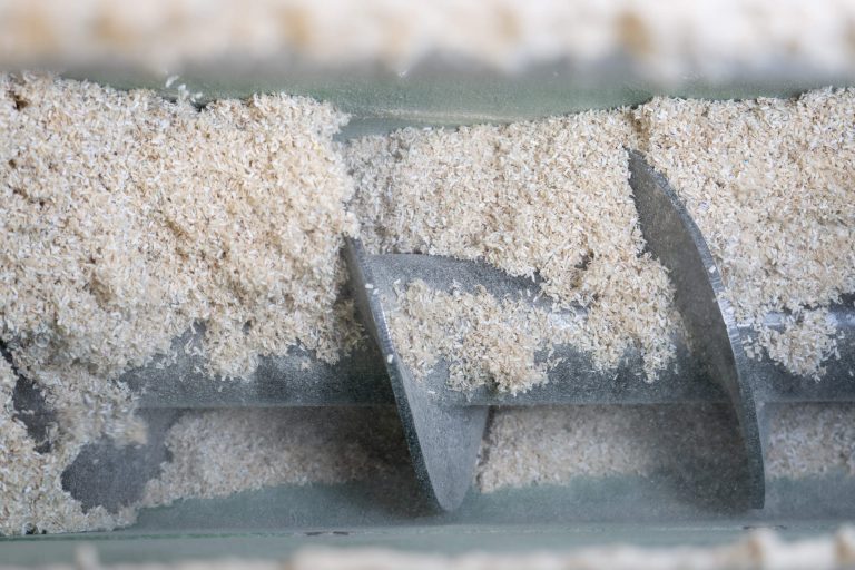 An auger that transports cardboard cuts to a briquetting press