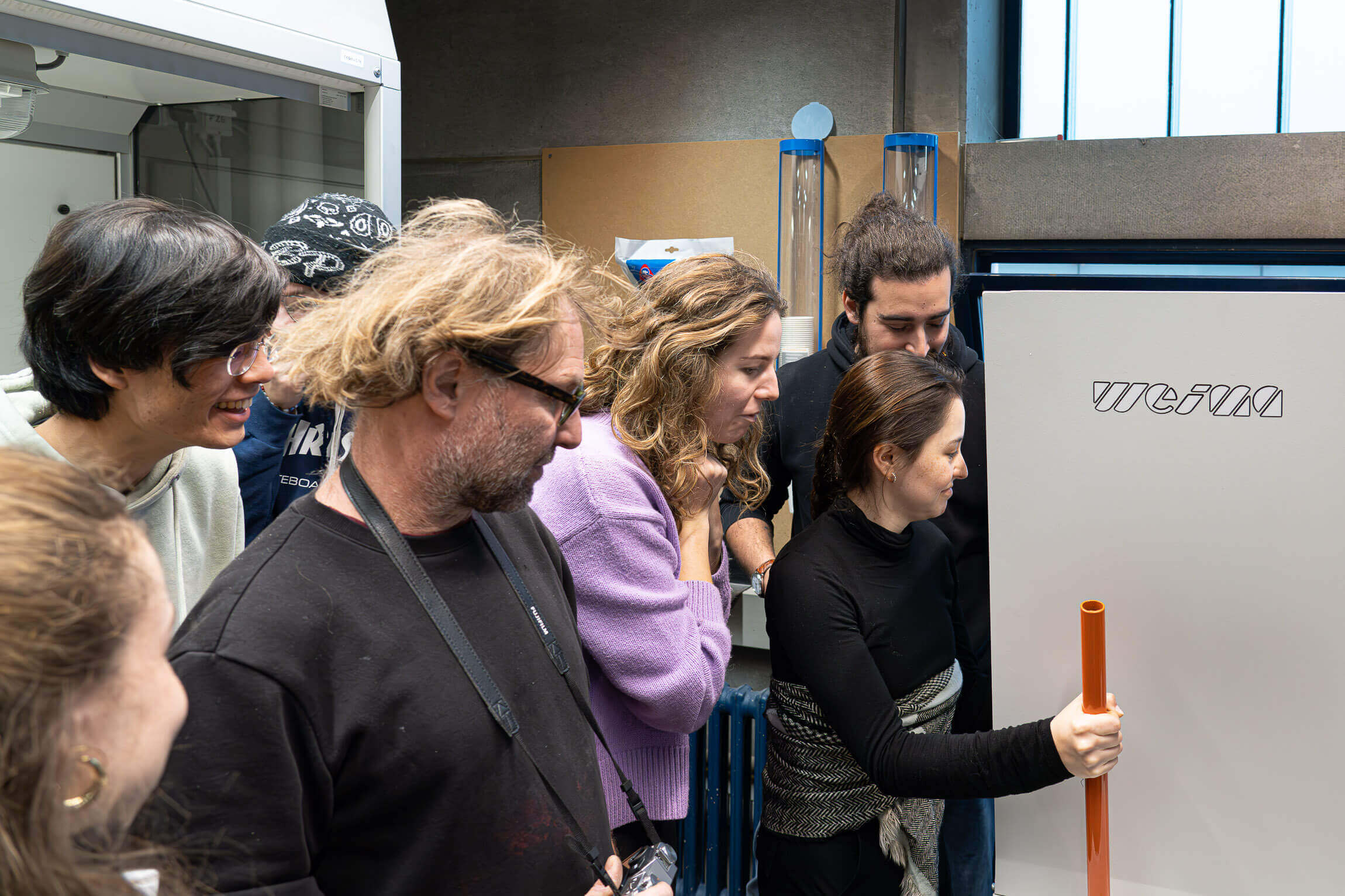 Students observing the shredding process through a window of a shredder