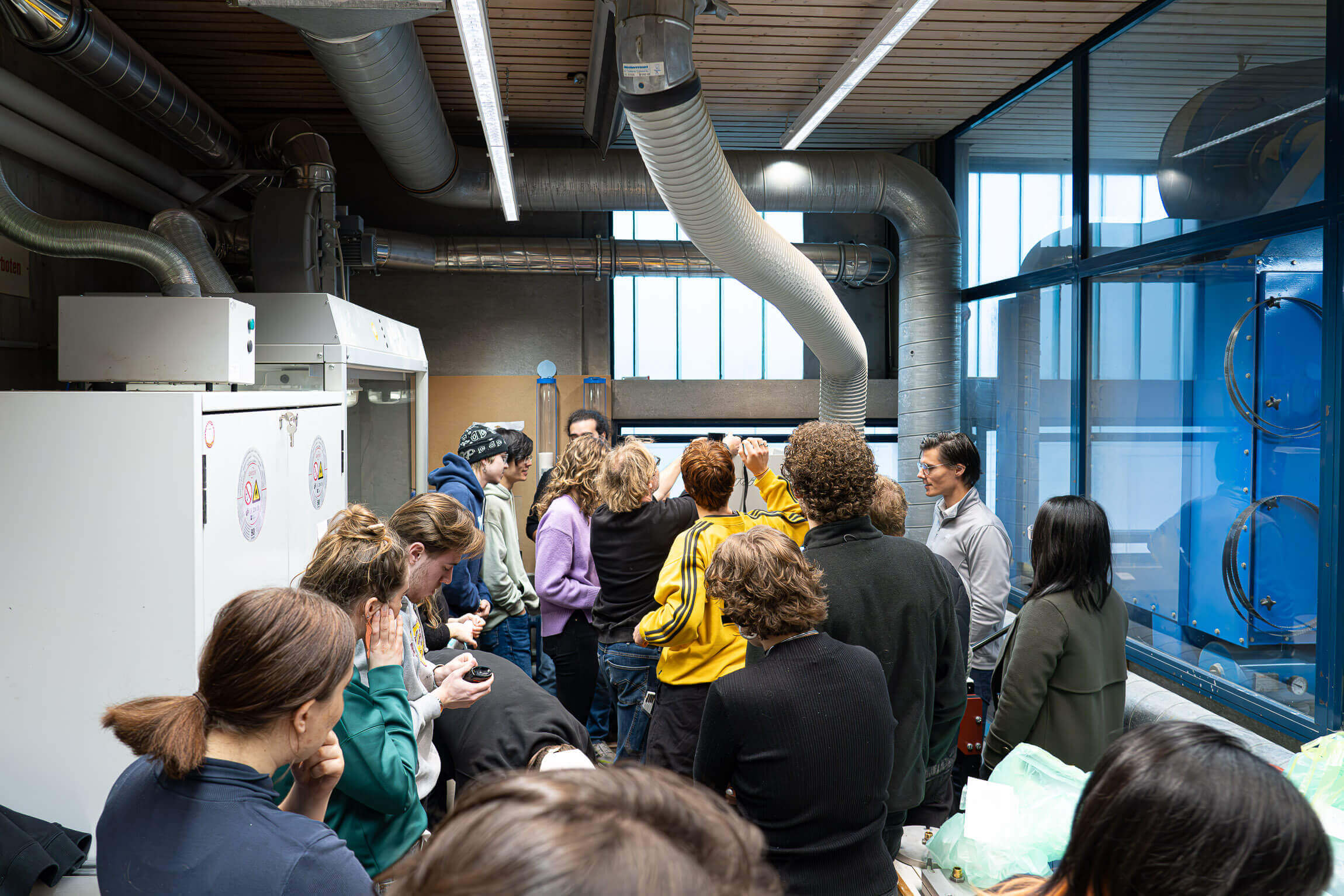 students gathering around weima shredder pro and injection machine