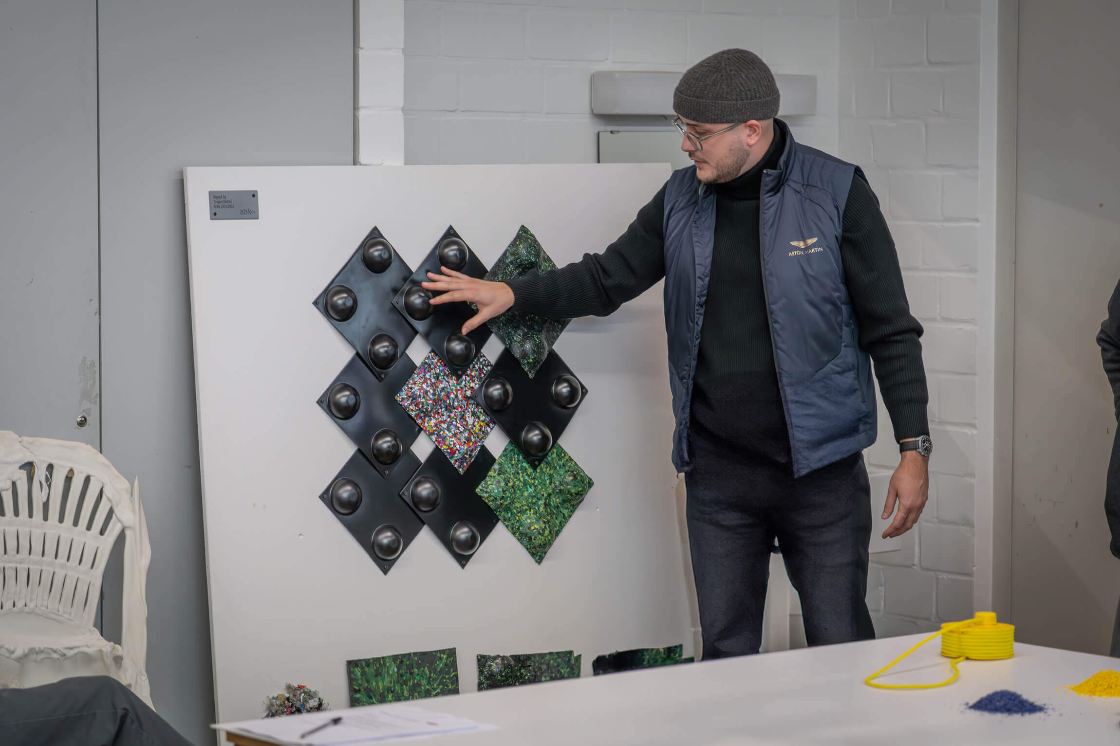 student presenting his thermoforming tiles on a board