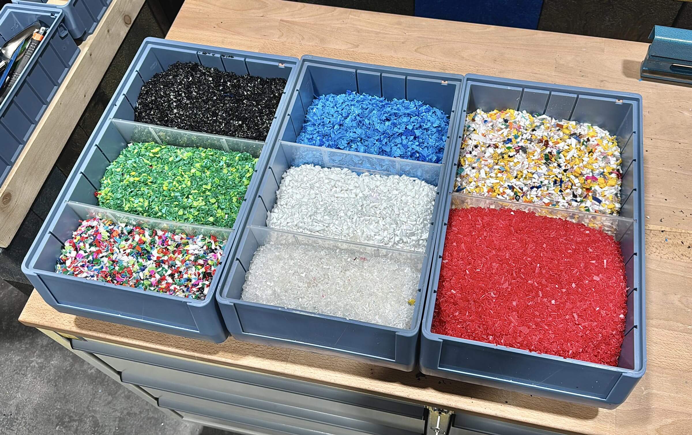 Shredded PP and HDPE plastic flakes in boxes