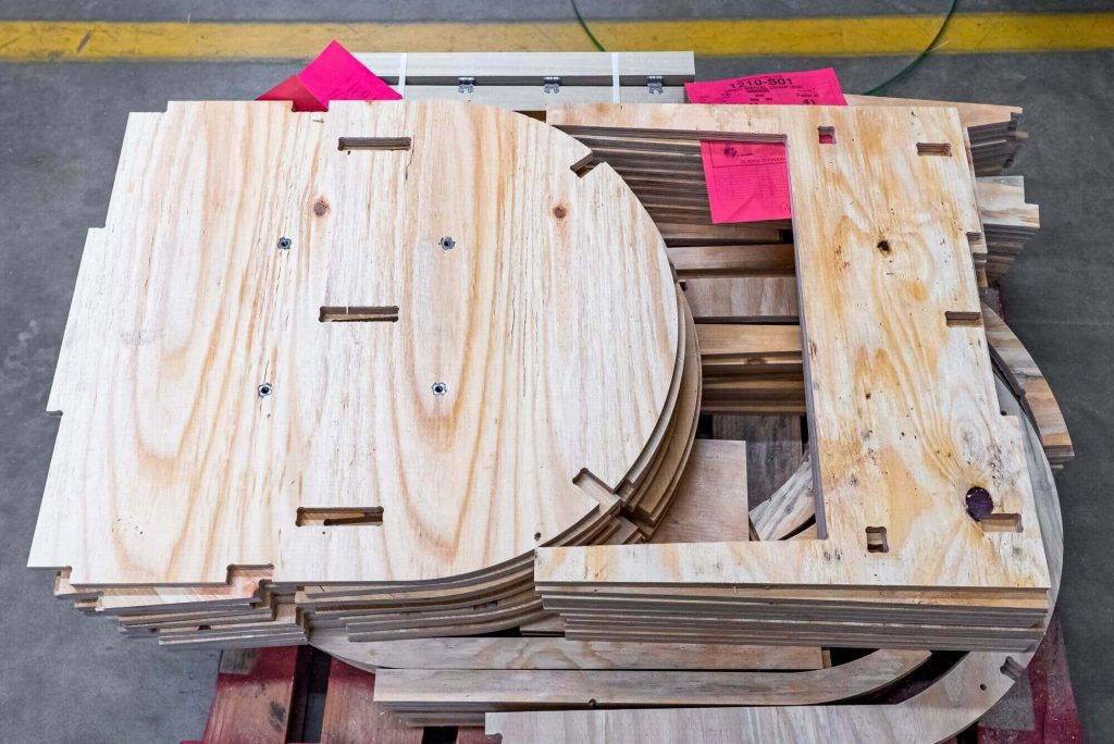 Plywood furniture parts are stacked neatly.