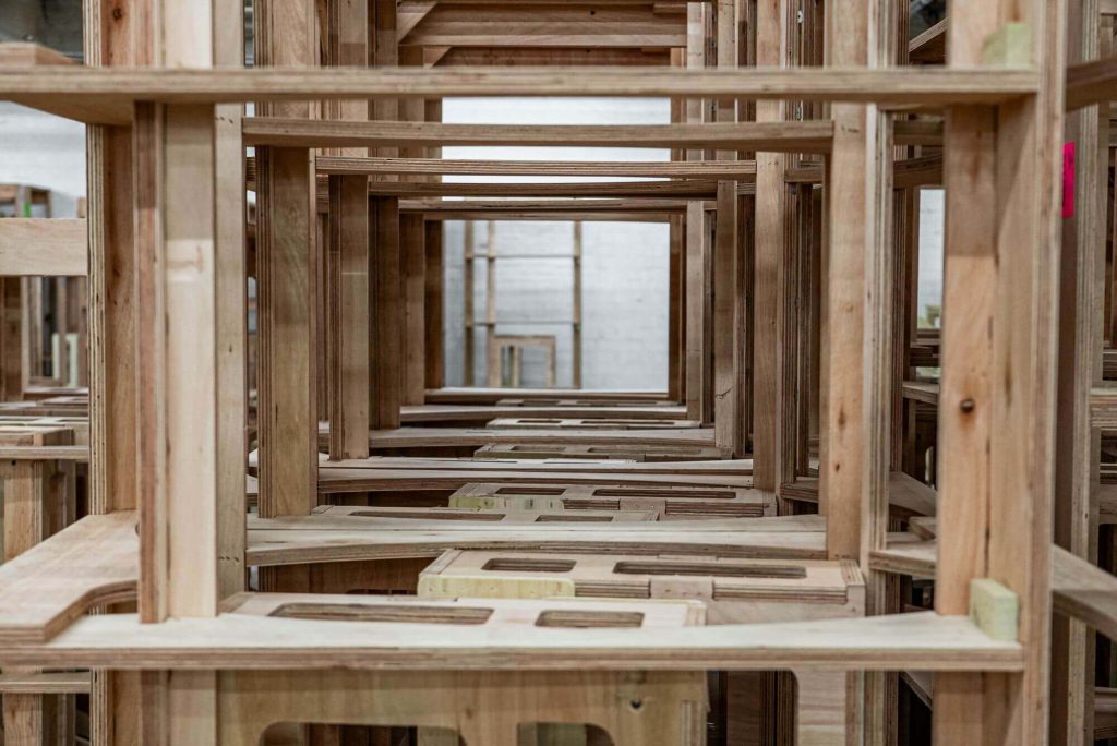 Assembled furniture is organized neatly in a warehouse.