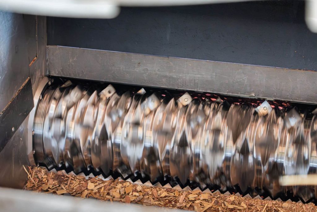 A rotor with wooden chips is in motion.