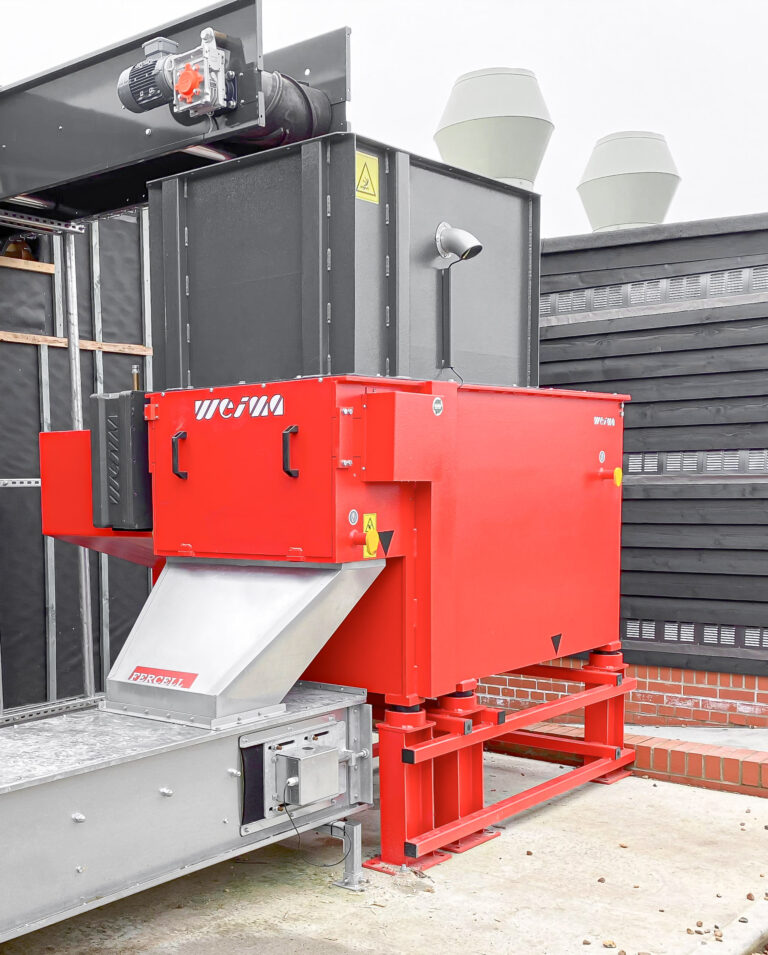 WEIMA WLK 6 S shredder in red design with connected extraction system in an industrial installation
