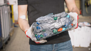 PET-Flaschen Pressling in den Händen eines WEIMA Mitarbeiters