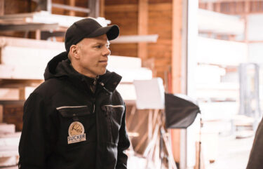 Arne Sucker stands in a woodworking shop