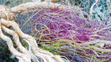 Different types of colorful fishing nets, ropes and other fibers