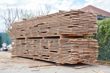 Stack with wooden planks before shredding with WEIMA machinery