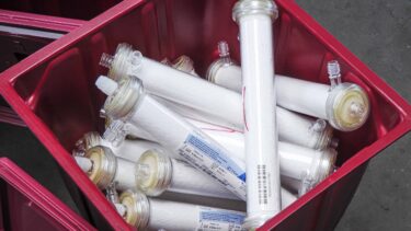 A red box full of glass filter ampoules