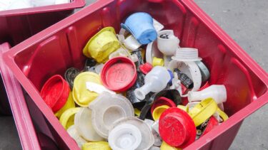 A red box with colorful containers of medical waste