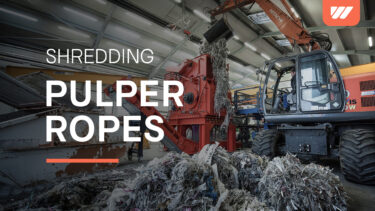 Gripper feeds pulper lumps into WEIMA PreCut 1500 shredder