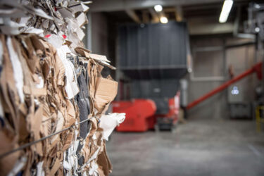 close up of shredded cardboard bales in a warehouse
