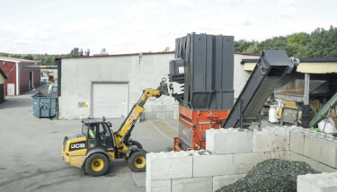 PowerLine shredder in outdoor installation, fed by a wheel loader