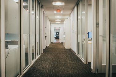 an office hallway with doors on either side