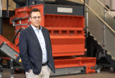Managing director Andreas Mack in front of a WKS 1800 shredder
