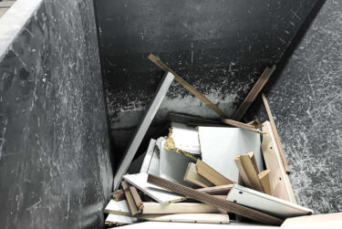 View into the hopper of the WEIMA ZM 40 four-shaft wood shredder filled with wood offcuts