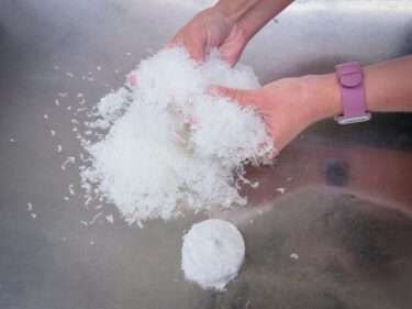 A collection of loose optical swarf is shown with a briquette next to it for space comparison.