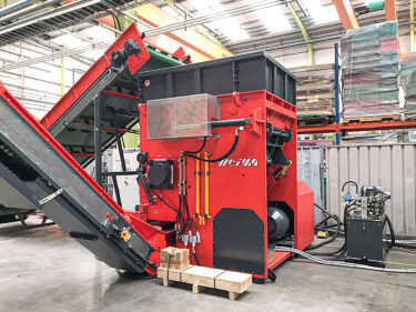 W5.14 plastic boxes shredder from WEIMA with infeed and output conveyors