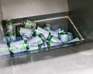 Second Fiddle beer cans are compressed with the E.200 drainage press