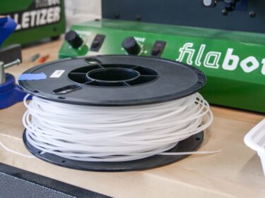 a spool of plastic filament sits on a table