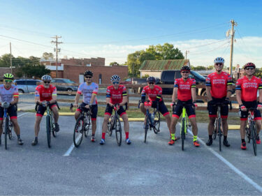 Velocity Cycling team members on their bicycles