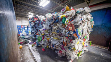 baled pst-consumer packaging on a conveyor belt