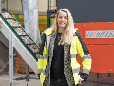 woman in front of a weima shredder