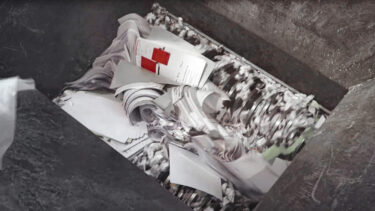 documents being shredded inside a weima four shaft shredder