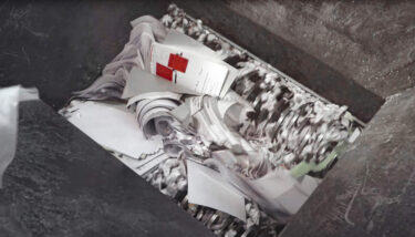 documents being shredded inside a weima four shaft shredder